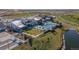 Aerial view of the community center featuring a pool, open lawn, and access to walking trails and a nearby pond at 21701 E 50Th Dr, Aurora, CO 80019