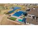 Community pool area with a large pool, wading pool, lounge chairs, and a nearby clubhouse at 21701 E 50Th Dr, Aurora, CO 80019