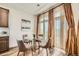 Charming dining area with a glass-top table, comfortable seating, and natural light that has stylish window treatments at 21701 E 50Th Dr, Aurora, CO 80019