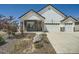 Charming two-story home featuring a three-car garage, stone accents, and a well-maintained front yard at 21701 E 50Th Dr, Aurora, CO 80019