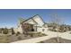 Charming two-story home featuring a three-car garage, stone accents, and landscaped front yard at 21701 E 50Th Dr, Aurora, CO 80019