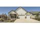 Charming two-story home featuring a three-car garage, stone accents, and a well-maintained front yard at 21701 E 50Th Dr, Aurora, CO 80019