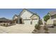 Charming two-story home featuring a three-car garage, stone accents, and landscaped front yard at 21701 E 50Th Dr, Aurora, CO 80019