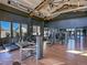 Spacious fitness center with modern equipment, large windows, and hardwood floors at 21701 E 50Th Dr, Aurora, CO 80019