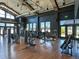 Spacious gym with modern equipment, including treadmills, weights, and machines, features wood floors and high ceilings at 21701 E 50Th Dr, Aurora, CO 80019