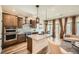 Open concept kitchen featuring an island, stainless steel appliances, and natural light at 21701 E 50Th Dr, Aurora, CO 80019