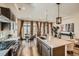 A kitchen featuring a central island, stainless steel appliances, and an adjacent dining area with lots of natural light at 21701 E 50Th Dr, Aurora, CO 80019