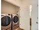 Well-equipped laundry room featuring a front-load washer and dryer at 21701 E 50Th Dr, Aurora, CO 80019