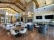 Bright living room with modern seating, fireplace, exposed beams, and ample space for gathering and relaxation at 21701 E 50Th Dr, Aurora, CO 80019