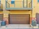 Exterior showing townhome garages and balcony with metal railings at 2869 Syracuse Ct, Denver, CO 80238