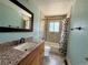 Bathroom featuring a granite vanity, a bath tub and shower with decorative tile accents at 8127 Lafayette St, Denver, CO 80229