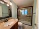 The updated bathroom features a modern vanity, toilet, and a shower with a glass door, offering a clean and stylish space at 8127 Lafayette St, Denver, CO 80229