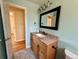 Bathroom features granite countertop vanity and views into the hallway at 8127 Lafayette St, Denver, CO 80229