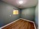 This compact bedroom features laminate flooring and a window that offers a view of the neighborhood, perfect for relaxation at 8127 Lafayette St, Denver, CO 80229