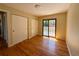 Bedroom with hardwood floors, closet doors and a door to a private deck at 8127 Lafayette St, Denver, CO 80229