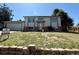 Split level home with neutral paint, brick accents and a nicely maintained lawn at 8127 Lafayette St, Denver, CO 80229
