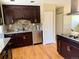 Kitchen featuring dark cabinets, stainless appliances, and granite countertops at 8127 Lafayette St, Denver, CO 80229