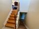 Traditional wood staircase with wrought iron accents leading to upper and lower levels at 8127 Lafayette St, Denver, CO 80229