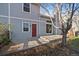 Exterior view of the home with a red door and concrete patio in the backyard at 6459 E Hinsdale Ave, Centennial, CO 80112