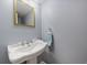 Powder room features a pedestal sink, framed mirror, and a towel ring at 6459 E Hinsdale Ave, Centennial, CO 80112
