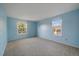 Bright bedroom features two windows, carpet flooring, and light blue colored walls at 6459 E Hinsdale Ave, Centennial, CO 80112