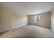 Spacious bedroom with neutral walls and carpet, with a sunlit window for natural light at 6459 E Hinsdale Ave, Centennial, CO 80112