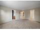 Large bedroom showcasing a neutral color scheme, plush carpeting, and ample closet space at 6459 E Hinsdale Ave, Centennial, CO 80112