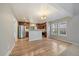 Well-lit kitchen featuring stainless steel appliances, a breakfast bar, and hardwood floors at 6459 E Hinsdale Ave, Centennial, CO 80112