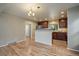 Open kitchen with stainless steel appliances, a breakfast bar, hardwood floors, and natural light at 6459 E Hinsdale Ave, Centennial, CO 80112