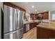 Modern kitchen featuring stainless steel appliances, granite countertops, and hardwood floors at 6459 E Hinsdale Ave, Centennial, CO 80112