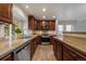 Bright kitchen showcasing stainless steel appliances, granite countertops, and wood flooring at 6459 E Hinsdale Ave, Centennial, CO 80112