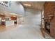 Bright open-concept living area featuring a brick fireplace, skylight, vaulted ceiling, and kitchen view at 6459 E Hinsdale Ave, Centennial, CO 80112