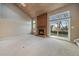 Bright living room featuring a brick fireplace, vaulted ceilings, skylight, and sliding glass door to the backyard at 6459 E Hinsdale Ave, Centennial, CO 80112