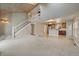 Open-concept living space featuring a staircase, kitchen with a breakfast bar, and hardwood floors at 6459 E Hinsdale Ave, Centennial, CO 80112