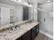Modern bathroom with double vanity, granite countertop, and glass shower at 4758 Kittredge St # 2, Denver, CO 80239