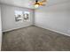 Spacious bedroom with neutral gray walls and carpet flooring at 4758 Kittredge St # 2, Denver, CO 80239