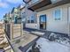 Modern townhome exterior with walkway and snow-covered landscaping at 4758 Kittredge St # 2, Denver, CO 80239