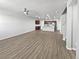 Open concept living room with kitchen view and wood-look floors at 4758 Kittredge St # 2, Denver, CO 80239
