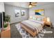 Virtually staged main bedroom with light gray walls and wood floors at 4758 Kittredge St # 2, Denver, CO 80239