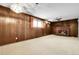 Finished basement features wood paneling, a brick fireplace, and a ceiling fan at 11936 E Oregon Cir, Aurora, CO 80012