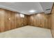 Finished basement with carpet and wood paneled walls at 11936 E Oregon Cir, Aurora, CO 80012