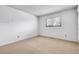Bright bedroom with neutral carpet, a large window, and ample natural light at 11936 E Oregon Cir, Aurora, CO 80012