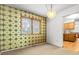 Cozy dining area with vintage wallpaper, a modern light fixture, and natural light at 11936 E Oregon Cir, Aurora, CO 80012