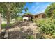 Backyard view featuring a covered patio, shed, and mature trees at 11936 E Oregon Cir, Aurora, CO 80012