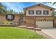 Charming two-story home with a brick exterior, landscaped front yard and well manicured lawn at 11936 E Oregon Cir, Aurora, CO 80012