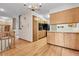 Hallway with hardwood floors, light cabinets, and views into the living areas at 11936 E Oregon Cir, Aurora, CO 80012