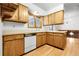 Traditional kitchen with wood cabinets, hardwood floors, and lots of natural light at 11936 E Oregon Cir, Aurora, CO 80012