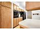 Kitchen featuring wooden cabinets, built-in appliances, and light countertops at 11936 E Oregon Cir, Aurora, CO 80012