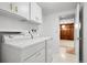 Laundry room with white cabinets, shelving, and washer and dryer at 11936 E Oregon Cir, Aurora, CO 80012