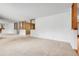 Open-concept living room offering neutral carpeting, ample natural light, and versatile layout at 11936 E Oregon Cir, Aurora, CO 80012
